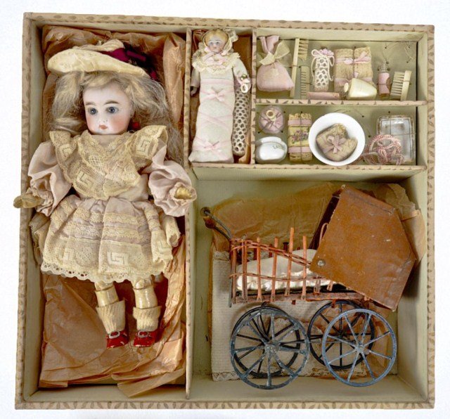 Jumeau labeled covered box: fitted with a 9 1/2" unmarked Bisque head doll, carriage, baby doll and other accessories. Provenance: Purchased in 2007 by Mrs. Hipp from Toyzine Auctions for $4995.00