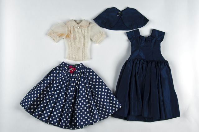 Cissy doll clothes: consisting of a tagged Cissy navy taffeta dress and cape, tagged Cissy white silk blouse with ruffled trim, and a blue dotted cotton skirt with rose décor at waist
