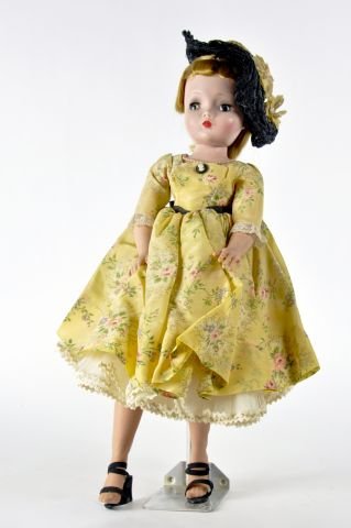 20" Madame Alexander Cissy 1957 dressed in yellow: nylon dress - floral print , big straw hat(not original) no bracelet or earrings - does have cameo - nylon stockings - loose shoes - straps are broken nice face and facial color