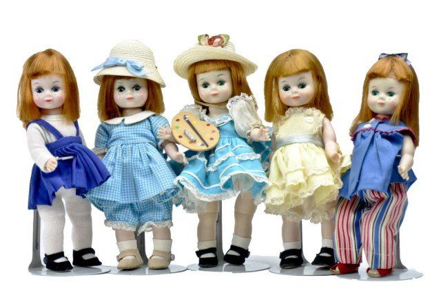 Lot of (5) Maggie Mixups 8" (1) blue romper with: easel (1) turquoise gingham outfit, (1) turquoise cotton, (1) yellow polished cotton & (1) red/white blue outfit, all outfits are tagged