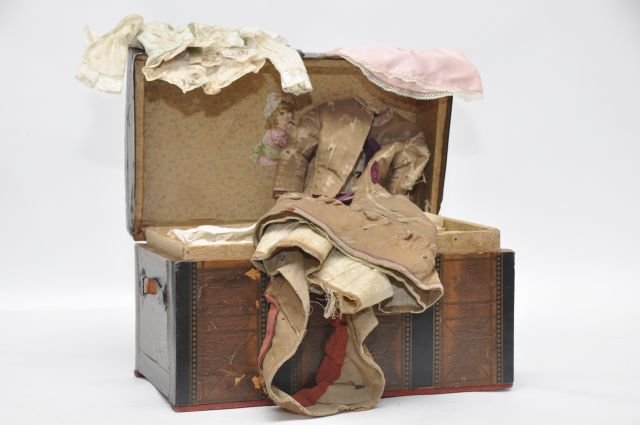 Victorian Doll Trunk, paper covered, leather: handles, wall paper inside. Early Doll Clothing, brown dress, as is; ribbon decorated skirt w/matching top; green velvet bonnet; booties; muff etc