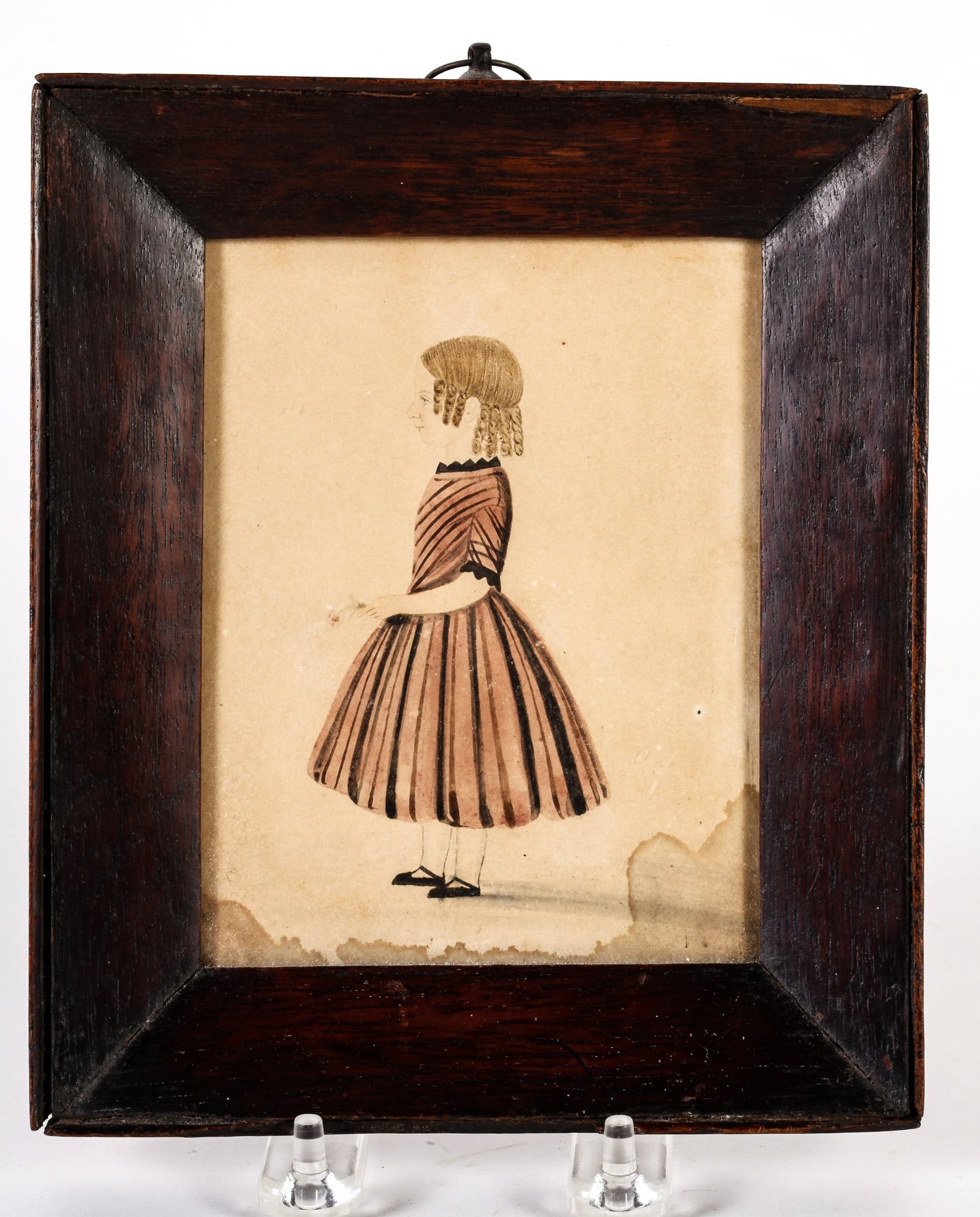 (19th c.) WATERCOLOR PORTRAIT OF A YOUNG GIRL: profile portrait of standing girl in striped dress, holding a flower, in a beveled mahogany frame 7 1/2 x 6 1/2 inches overall