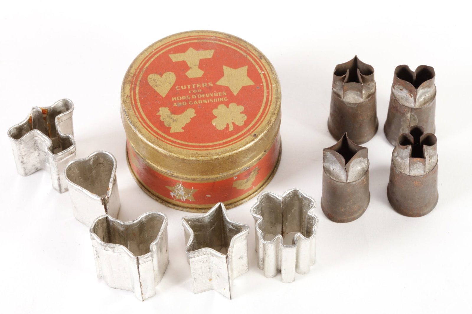 CUTTER'S FOR HOR'S D'OEUVRES AND GARNISHING: Five cutters in original tin canister; together with set of four cutters: heart, club, spade, and diamond.