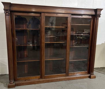 EARLY 20TH c MAHOGANY TRIPLE DOOR BOOKCASE: With sliding doors and adjustable shelves. 58 x 72 x 18 inches deep.