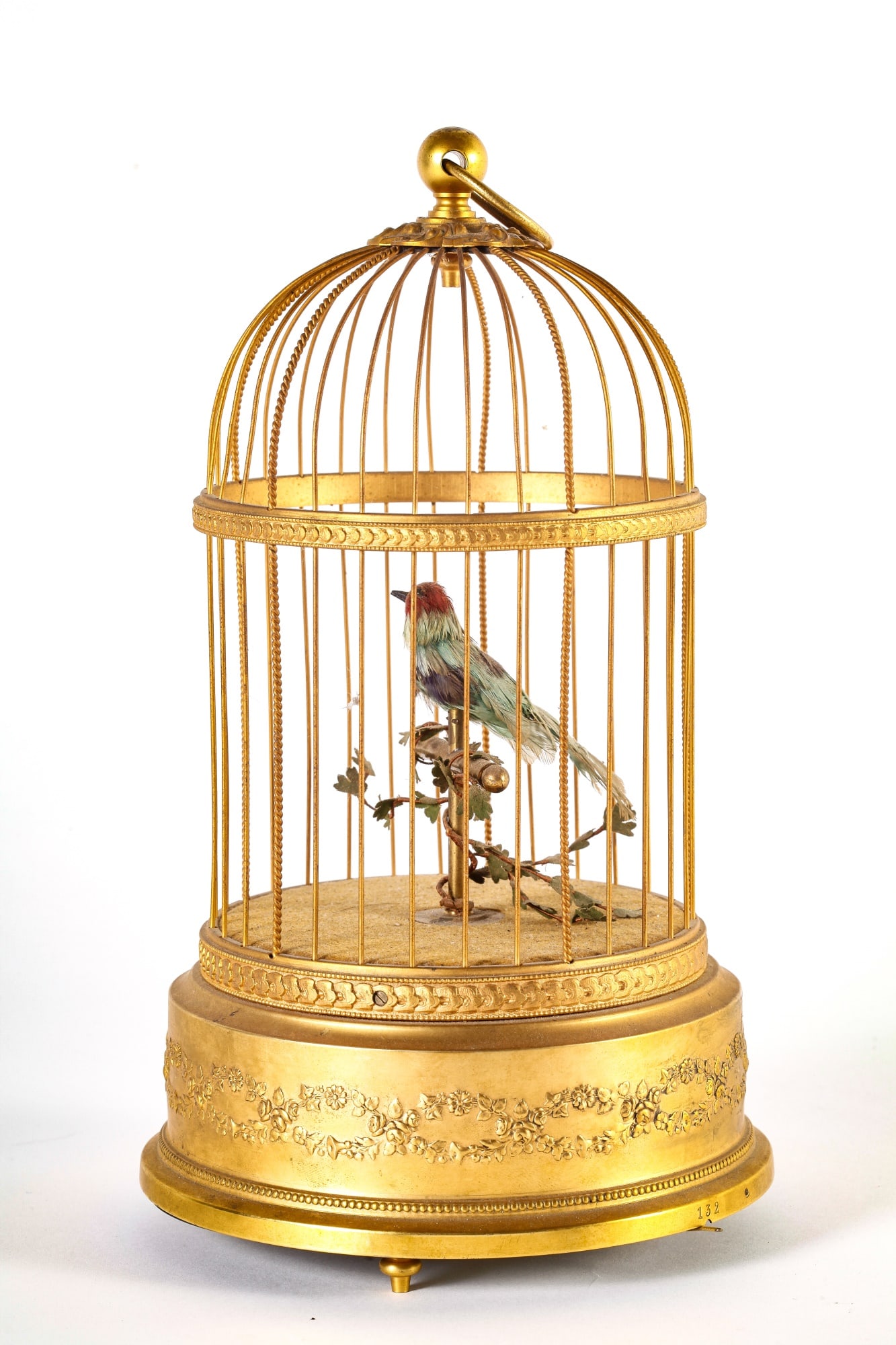 SONGBIRD IN CAGE: Single singing bird in bronze cage, 11 1/2 inches high.