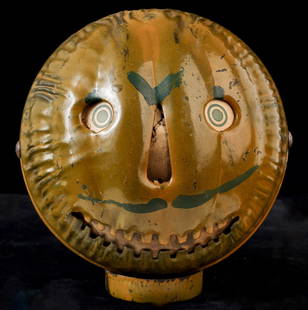 VINTAGE HALLOWEEN TIN PARADE PUMPKIN LANTERN: ca. 1900. Pressed tin construction with original painted finish, paper face insert, 7 inches high.