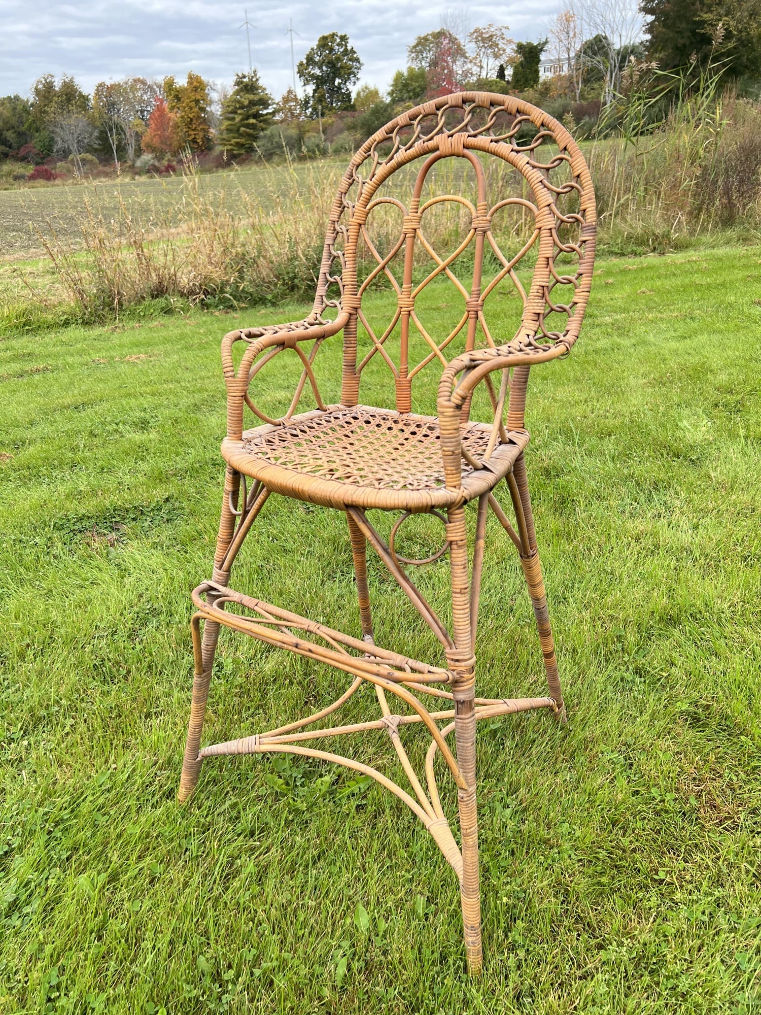 WICKER CHILD'S HIGH CHAIR: With cane seat. 37 1/2 inches high.