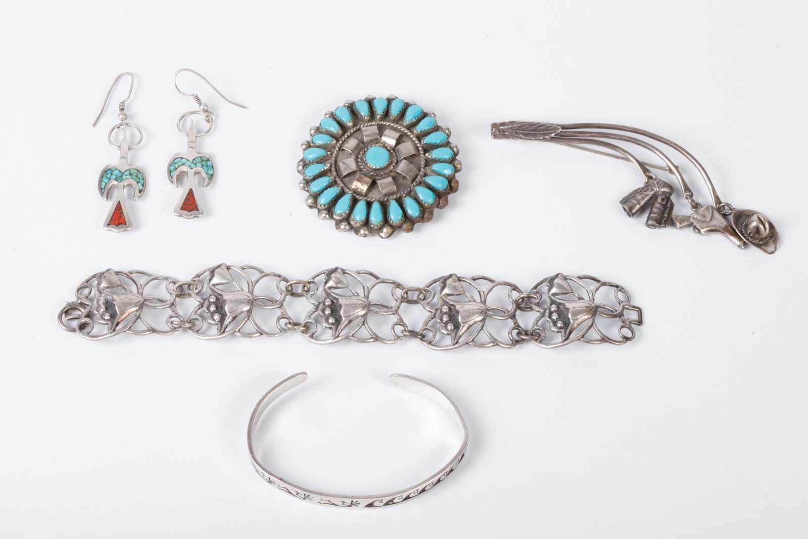 GROUPING OF NATIVE AMERICAN JEWELRY ETC: Including: Brooch inlaid with turquoise, bracelet signed Myron Pantean, pair of bird earrings, a western themed pin with cowboy hat, chaps and gun, together with a bracelet marked sterling. 2.4 troy o