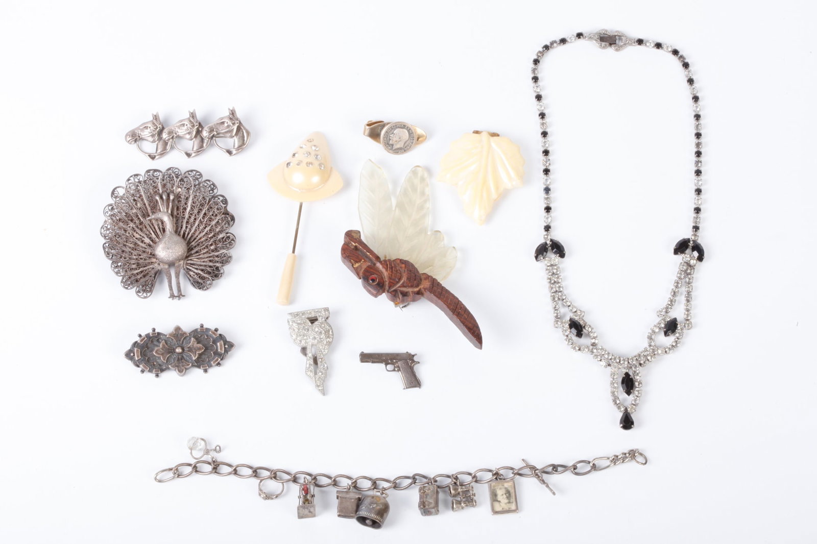 GROUP OF VINTAGE COSTUME & STERLING JEWELRY: Including: Robbins & Co. Colt 45 pistol pin marked sterling, silver filigree peacock brooch, charm bracelet, racehorse pin, together with dragonfly brooch, rhinestone necklace etc.