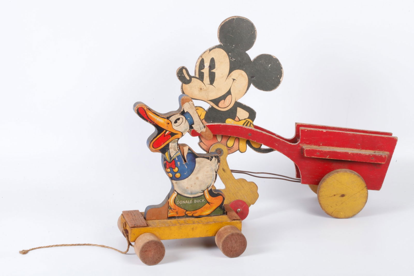 WALK DISNEY'S MICKEY MOUSE & DONALD DUCK PULL-TOYS: Spring steel under Fisher Price Donald Duck makes noise as front wheels bob. Mickey's legs "walk" as rear wheels turn. 9 and 12 inches