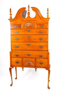 CENTENNIAL QUEEN ANNE STYLE BONNET TOP HIGH BOY: (Early 20th c) Bench made with flame finials and carved fans. nut-brown figured maple. 6'3" x 38 x 19 inches (case)