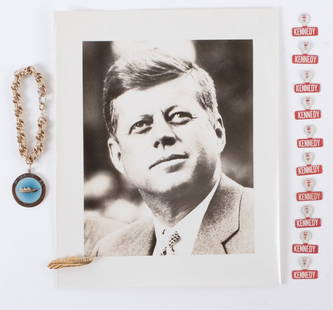 SENATOR JOHN F. KENNEDY CAMPAIGN MATERIAL: (10) Kennedy lapel tabs, "Kennedy 60" PT 109 charm bracelet, "Kennedy 60" PT 109 lapel pin and an 8 x 10 inch black and white photograph of John F. Kennedy. Provenance: Rosalie Helm longtime assistant