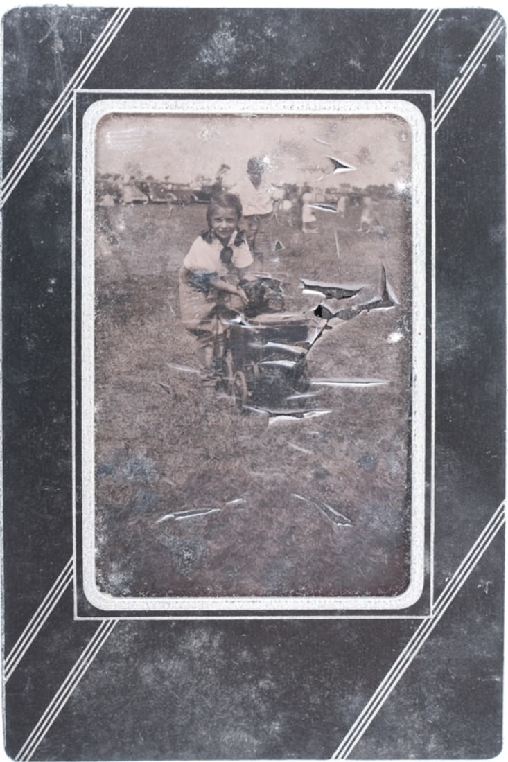 TINTYPE OF CAROLINE LEE BOUVIER (1933-2019): Pictured with dog in stroller and presented in a period art deco mat. 3 1/2 x 2 1/2 inches. *Note: This is an unpublished photograph of the future Lee Radziwill. Provenance: Yusha Auchincloss archive 