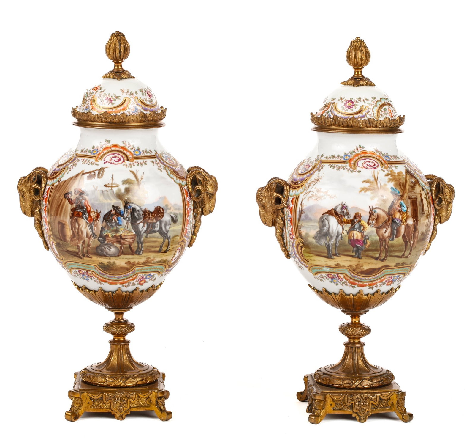 PAIR OF MEISSEN PORCELAIN URNS: Hand painted with cartouches of landscapes and travelling Cavaliers. Ormolu mounts include: floral finials, rams head handles and base. both fonts and covers are signed. Height 17 inches.