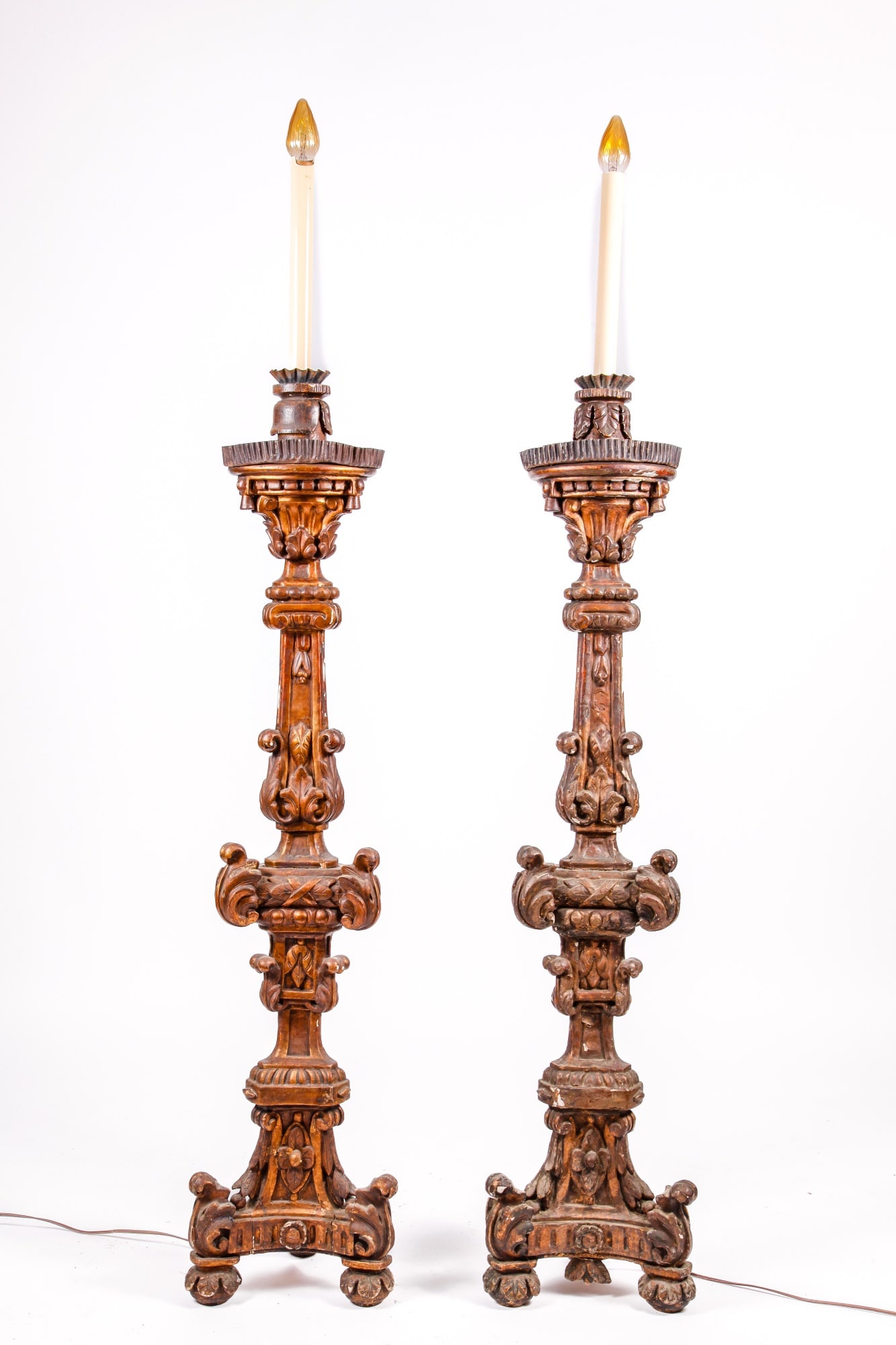 PAIR OF CONTINENTAL CARVED and GILT TORCHES: 48 inches (to top of pedestal) 67 inches (to top of bulb)
