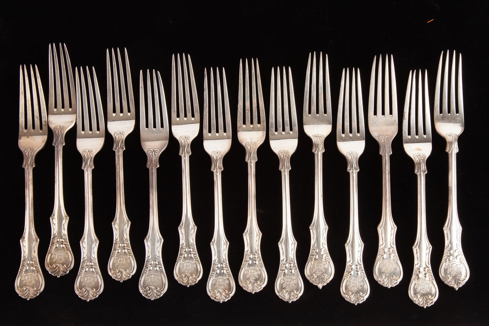 SET of (14) SILVER DINNER FORKS: Each with an armorial crest of top of handle. (12) of the forks marked 900 together with (2) sterling examples. Each 8 1/2" long. 41.5 OZT