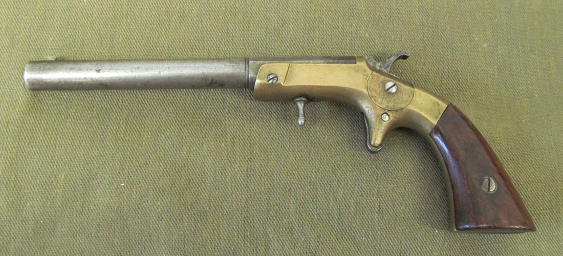FRANK WESSON SINGLE SHOT POCKET PISTOL 22: sn 9935, 22 caliber, round to octagonal barrel, two line address on barrel, brass frame, walnut grips.