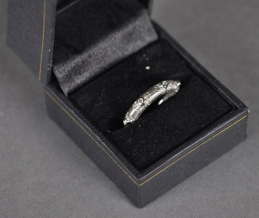 14k White gold band set with diamonds: 14k White gold band set with six small diamonds, size 7, DWT 2.6 DWT