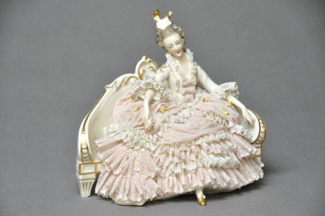Dresden style lace figure of woman on settee: Dresden style lace figure of woman on settee with fan. H: 6 1/2"