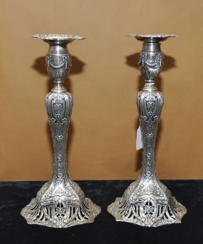 Pair of sterling silver repousse candlesticks: Pair of sterling silver repousse candlesticks on reticulated bases, retailed by J.E. Caldwell & Co.
