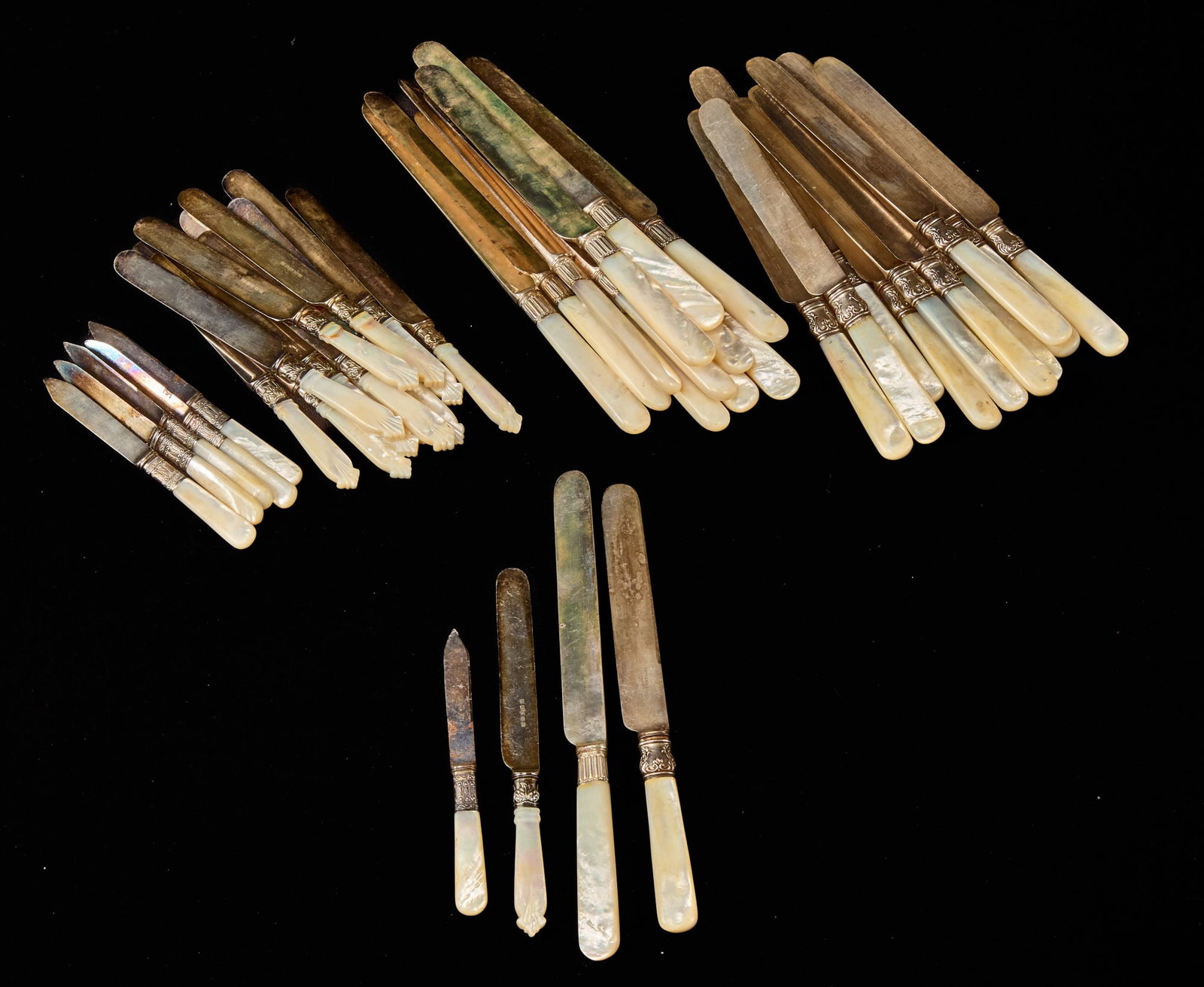 GROUPING of CUTLERY with MOTHER of PEARL HANDLES: Including: (6) Towle Manufacturing Co fruit knives, (12) Hennegen Bates & Company butter knives and (12) dinner knives and (12) Meriden Cutlery dinner knives with fluted bolsters, 10 inches (and small