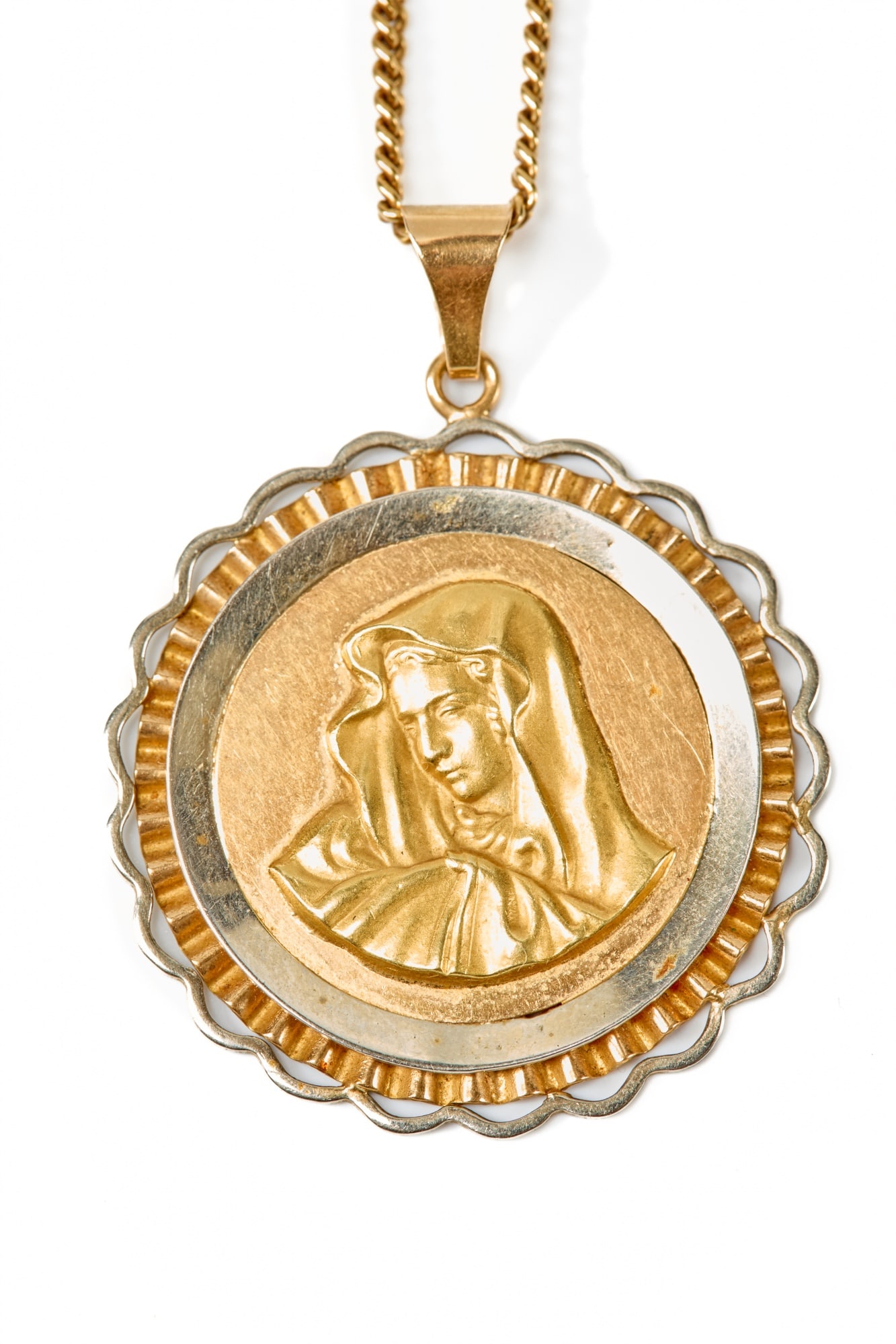 ITALIAN 18K GOLD MADONNA PENDANT & CURB CHAIN: Hallmarked. 35mm pendant bordered in 18K white gold. 11.45 dwt. Chain length measures 20 inches.