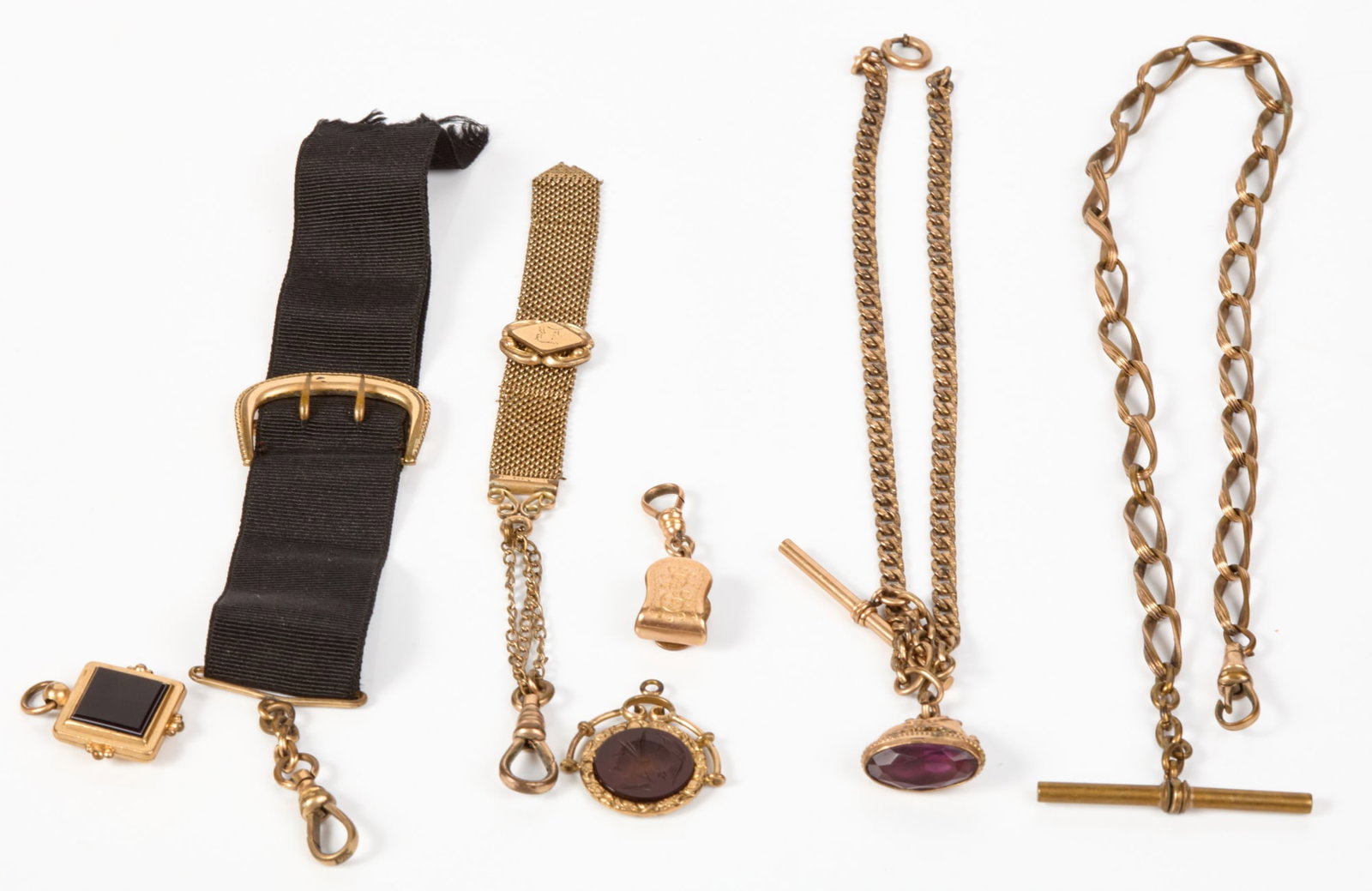 GROUPING of ANTIQUE GOLD-FILLED CHAINS and FOBS: Including: Intaglio cut with Mercury, faceted amethyst, and onyx.