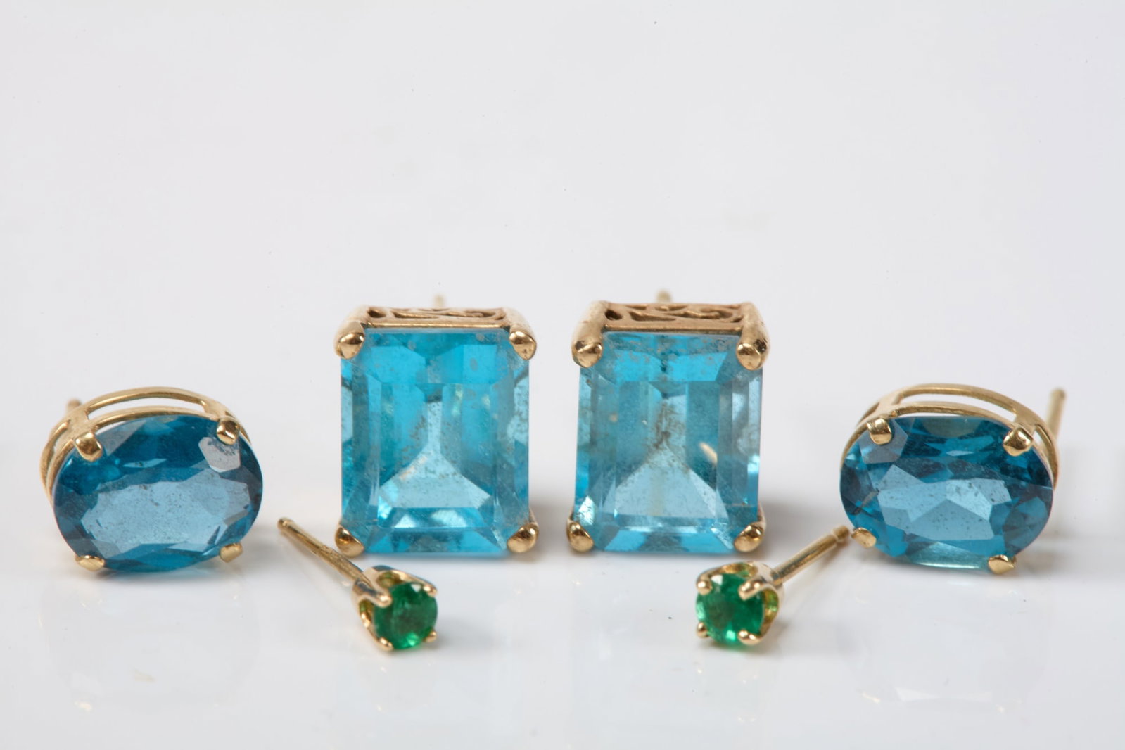 10k &14k GOLD EARRINGS with BLUE TOPAZ & EMERALDS: 10k Emerald cut is 10mm. 14k Oval is 9mm. 14k Emerald is 3mm. 3.3dwt (total weight)