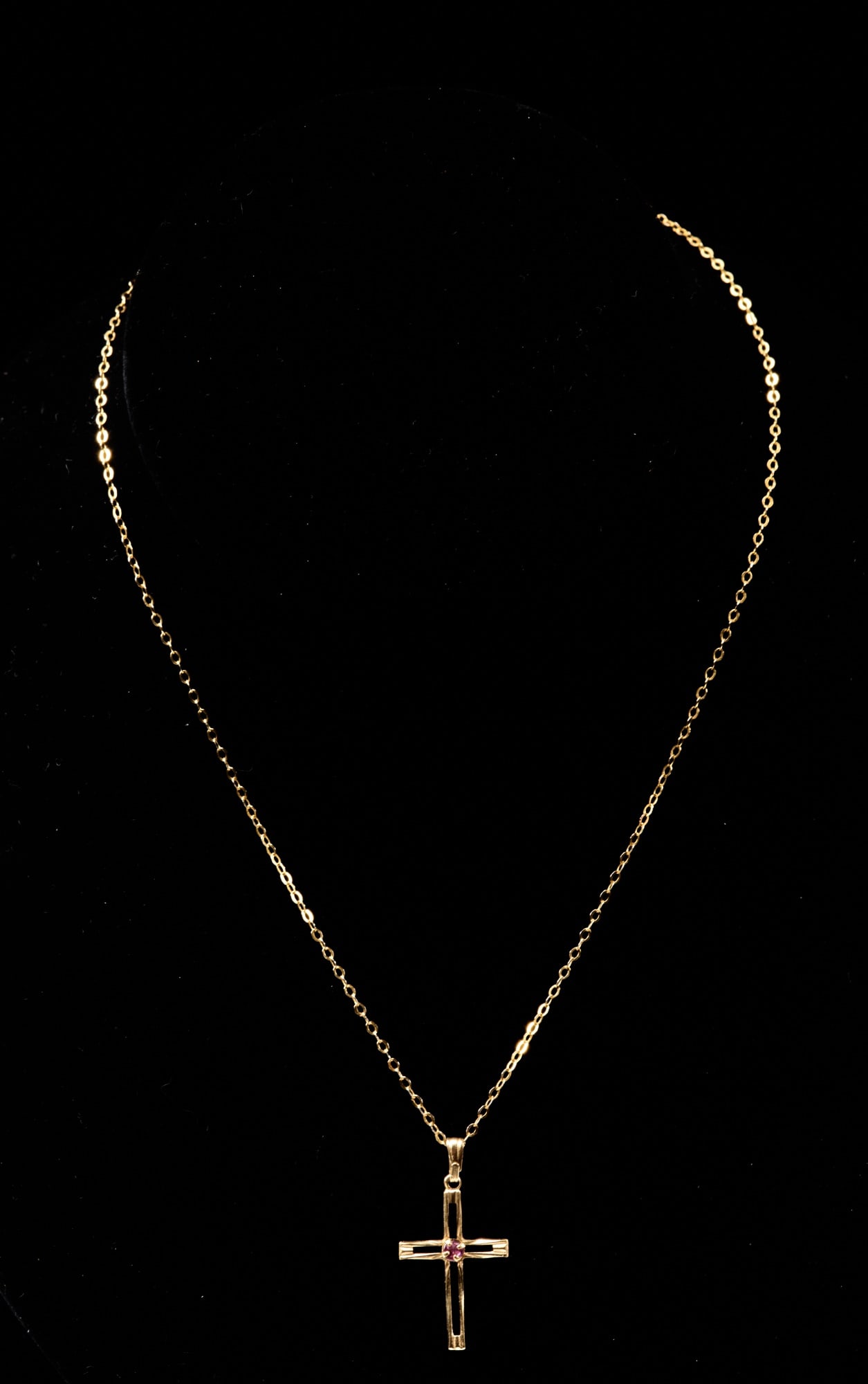 14k GOLD CROSS set with SEMI PRECIOUS STONE: 1 inch .3 dwt Together with a gold plated 15 inch chain.