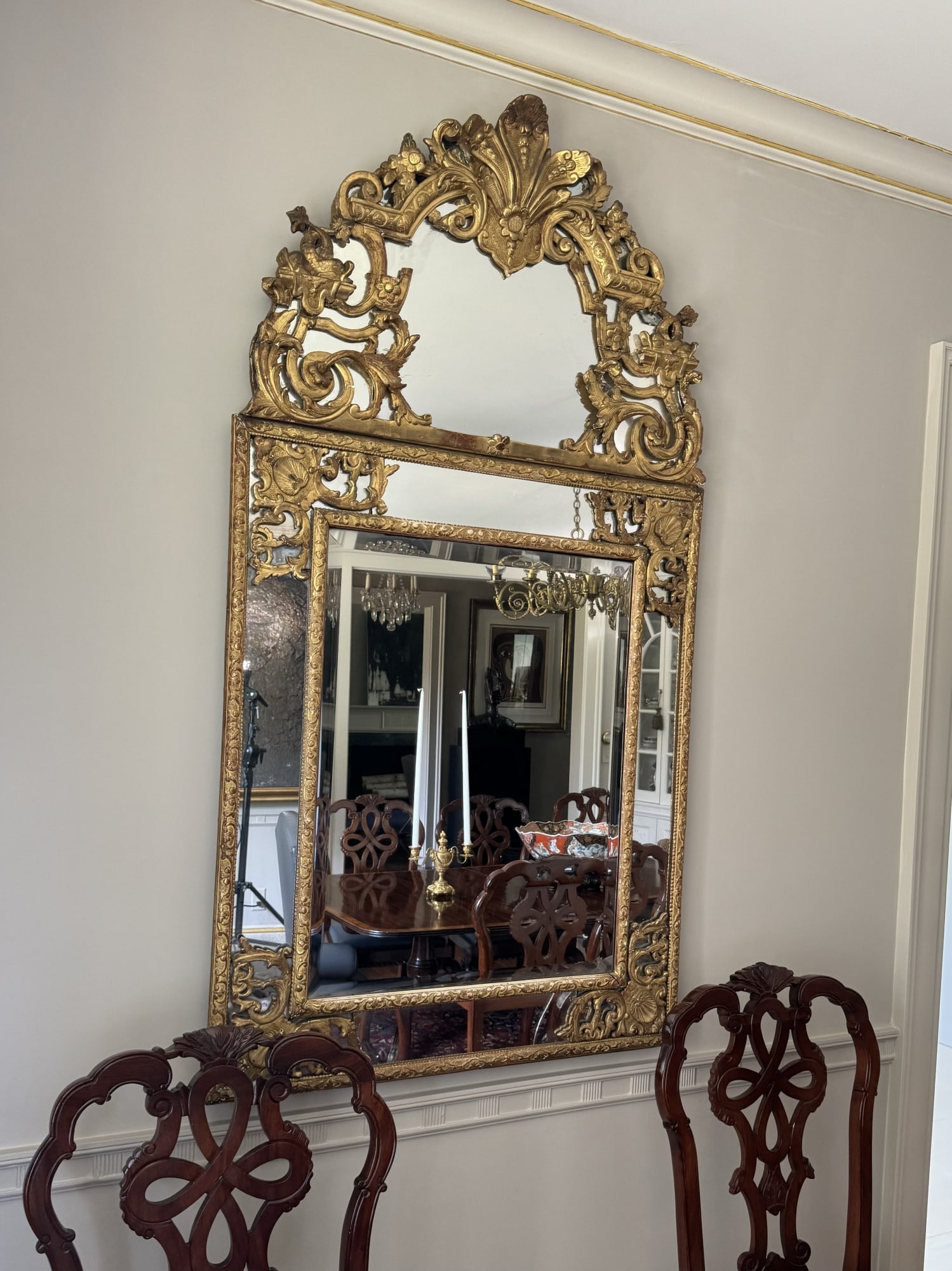 FABULOUS CARVED LOUIS XIV GIILTWOOD MIRROR: This fabulous (18th c) French mirror in the manner of Jean Berain, decorator to King Louis XIV, features a mirrored pediment that is carved with flora, dolphins, scrollwork & acanthus with the main bo