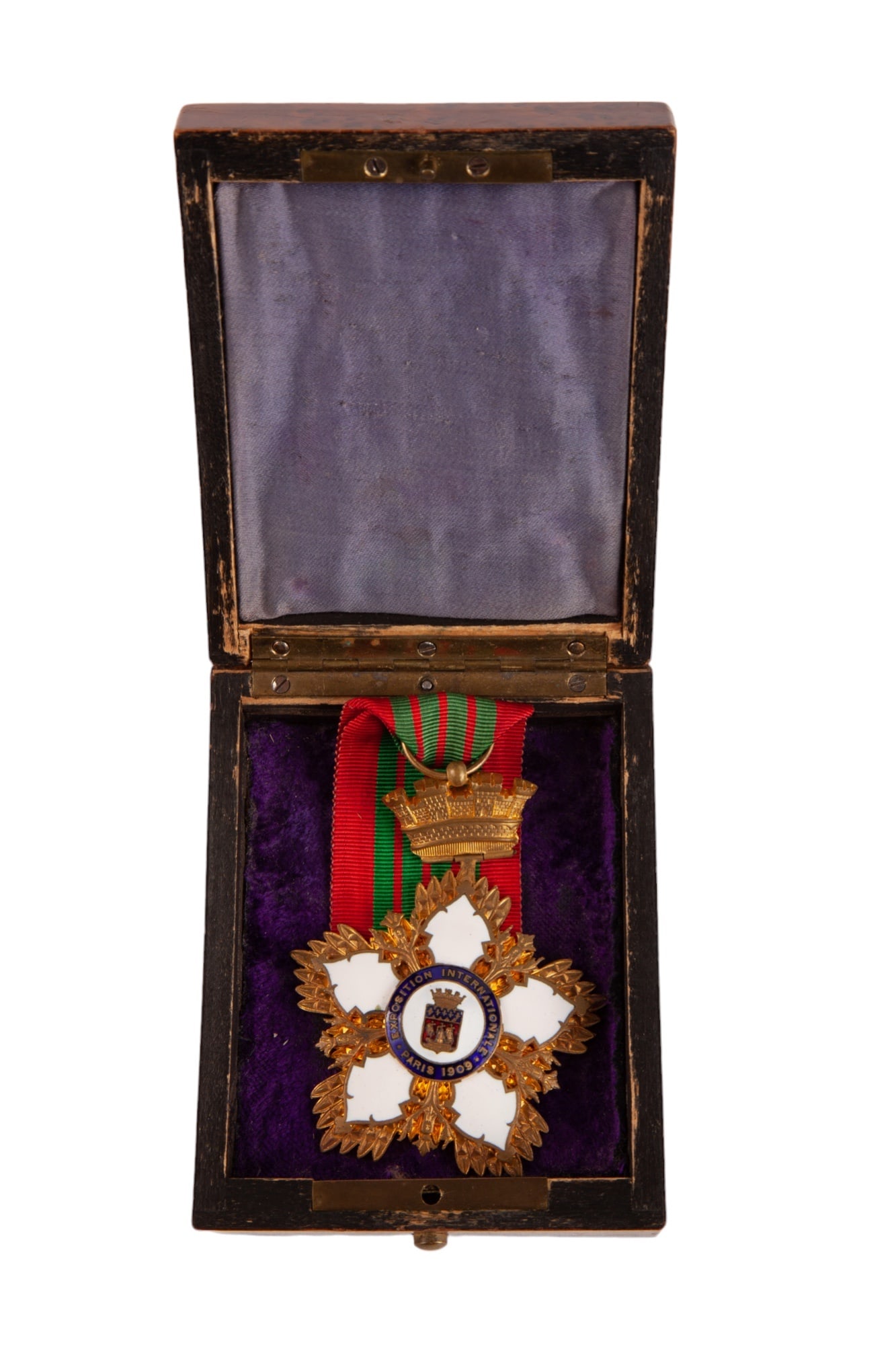 1909 PARIS EXPOSITION INTERNATIONALE MEDAL: Star form medal with enamel petals and enameled medallion displaying the Paris Coat of Arms, attached to a green and red striped silk ribbon with a crown form castle. Housed in a nice birdseye maple c