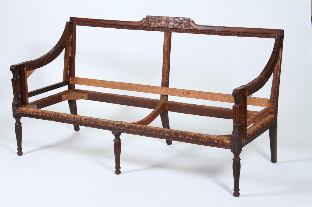 New York Federal Period Settee: (Late 18th /early 19th c.) mahogany settee with crest rail carved in high relief including a pineapple flanked by florets and acanthus leaves. Arms carved with acanthus leaves terminate at square acan