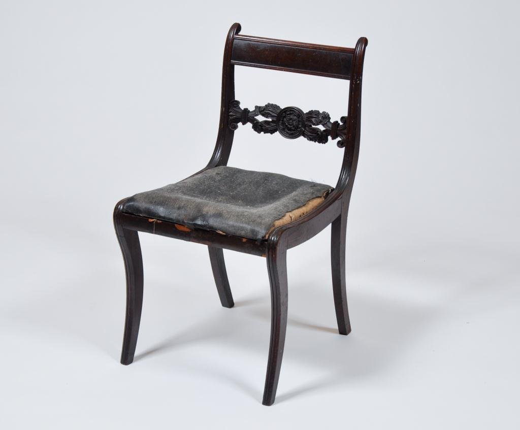 American Classical Phyfe School Side Chair: (19th c.) Duncan Phyfe School mahogany side chair with medallion flanked by acanthus leafs carved splat and molded sabre legs. Tattered horse hair slip seat. Condition: early as found condition Size: