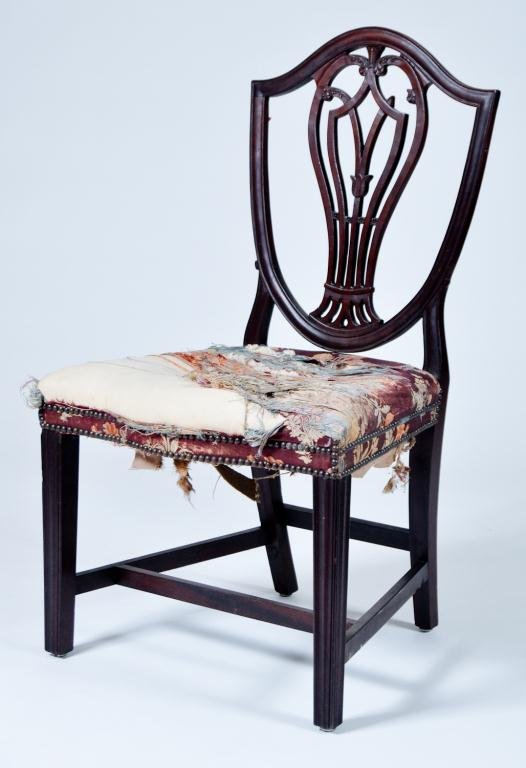 Federal Period Shield-Back Side Chair: (18th/ 19th c.) Federal period mahogany shield back side chair with tulip carved and pierced splat, serpentine seat and tapered molded Hepplewhite legs. Condition: break and loss to splat, tattered up