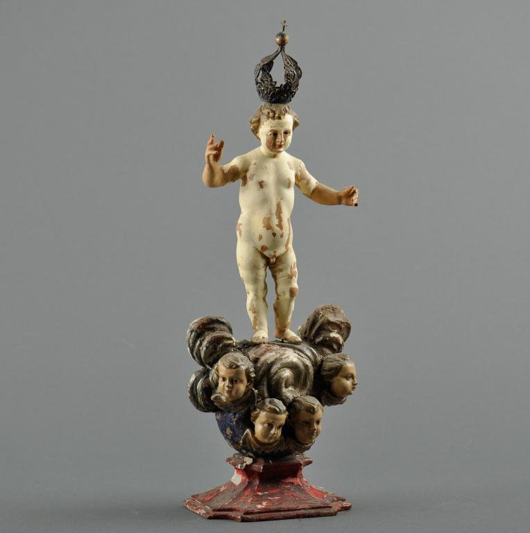 Santos Baby Jesus: Late 18th/Early 19th century on stand with four three dimensional faces, silver crown, wood Condition: loss to fingers, extensive paint loss Size: 18"loss to fingers, extensive paint loss18"
