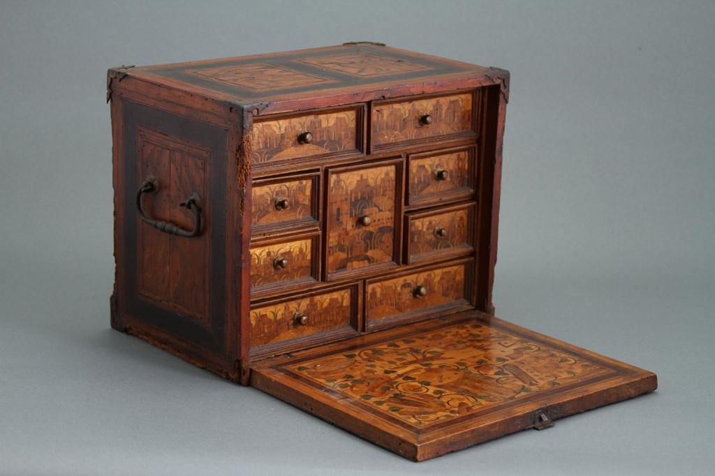 A 18th c. Fall Front Inlaid Jewel Chest w/ Brass M: Fall front chest with elaborate wood inlaid decoration, nine drawers Condition: some loss to veneer, some brass present but not attached Size: 11" x 9" x 13 1/2"some loss to veneer, some brass present
