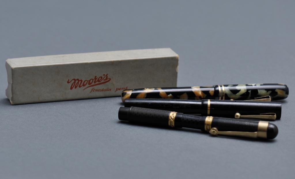 Moore's Fountain Pens: Lot of three "Moore's" fountain pens with one box, two with maniflex nibs, one with the Moore nib Size: 5" (and smaller)5" (and smaller)