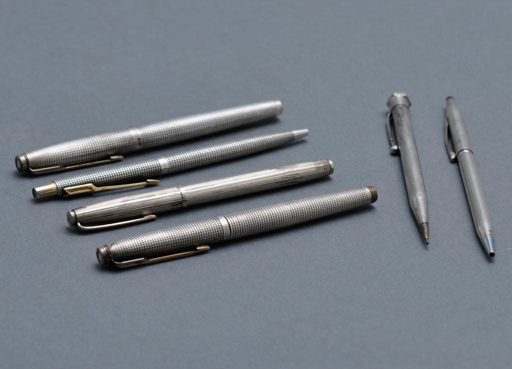 Lot of Pens and Pencils: Lot of five sterling pens and pencils including three Parker pens, one fountain; one Dunhill; one Cross monogrammed "MV RM' 75"; English mechanical pencil J.M. & Co. Condition: used some dents Size: 5