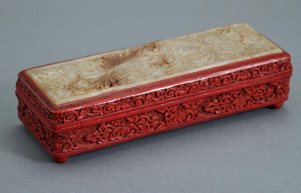Chinese Cinnabar Box Jade Top: (20th c.) red lacquer ware box with turquoise enamel interior and carved and reticulated white jade top Condition: good Size: 2 1/2" x 10" x 3 1/2"good2 1/2" x 10" x 3 1/2"