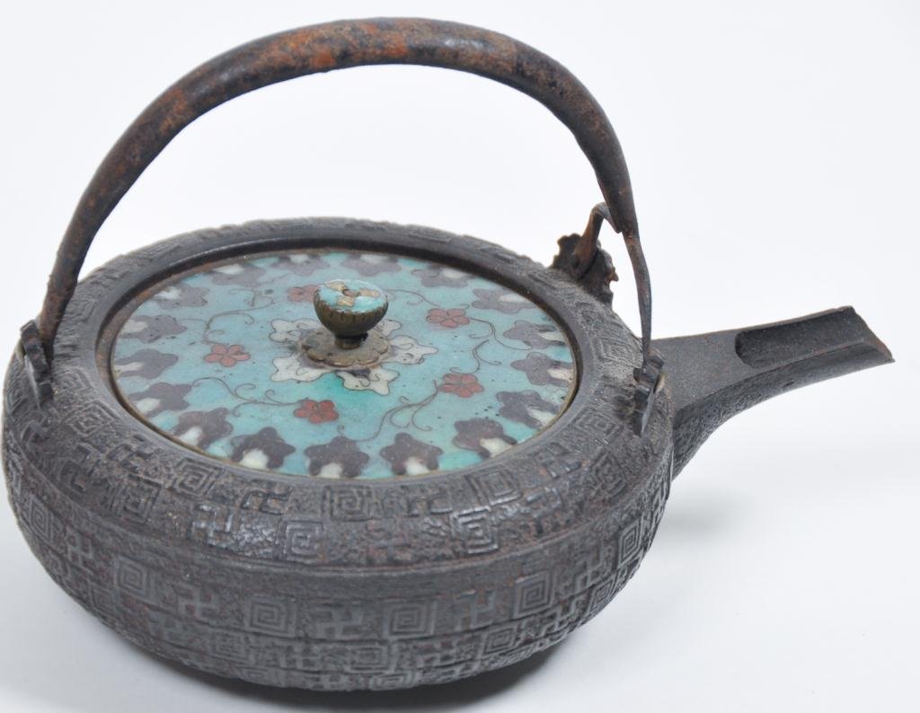 (19th c.) Japanese Cast Iron Tea Pot: Meiji period tetsubin with interesting raised rolling log motifs including and cloisonne cover. Condition: good Size: 5 1/2" x 8"good5 1/2" x 8"