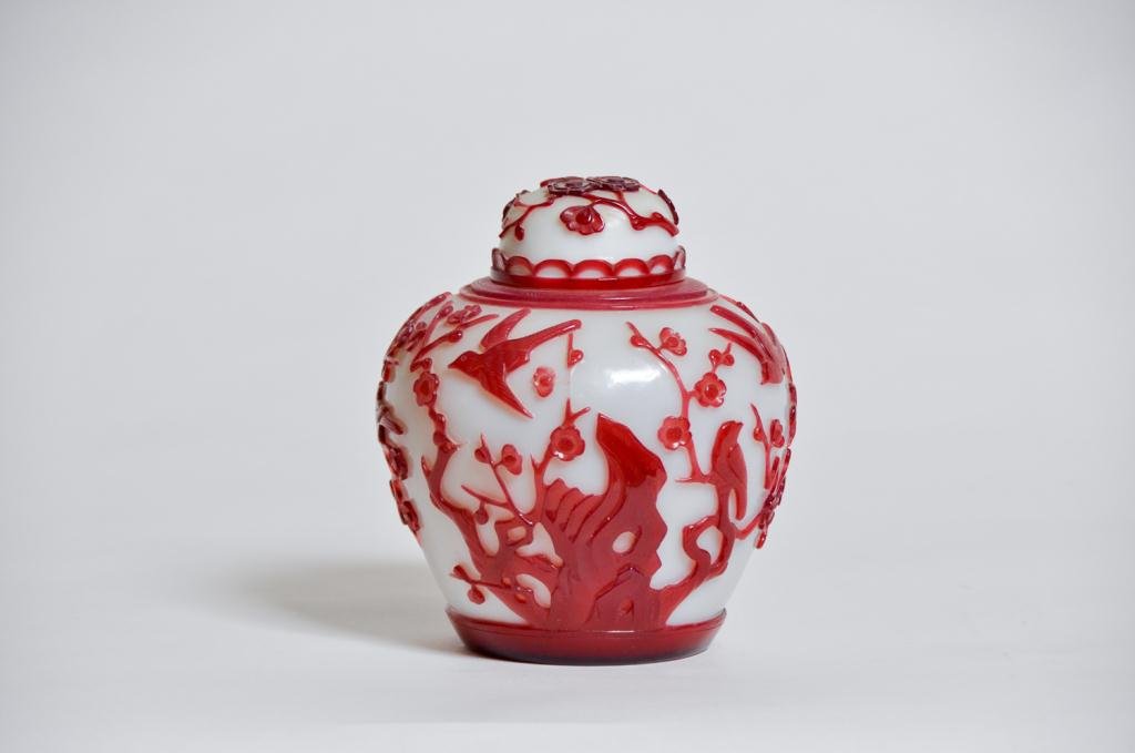 A 19th c. Chinese Peking Glass Covered Jar: Red and White Peking glass covered jar with flowering tree and bird decoration Condition: good Size: 6 1/2"good6 1/2"