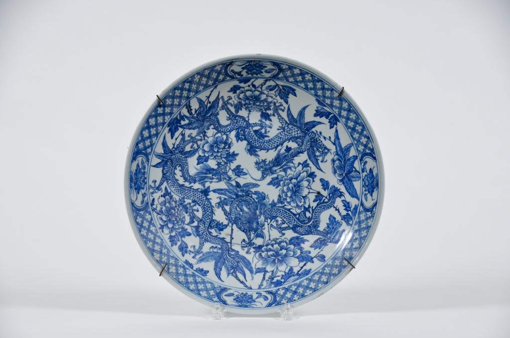 Blue & White Chinese Charger: Charger decorated with dragons against floral background Condition: good Size: 14 1/2"good14 1/2"