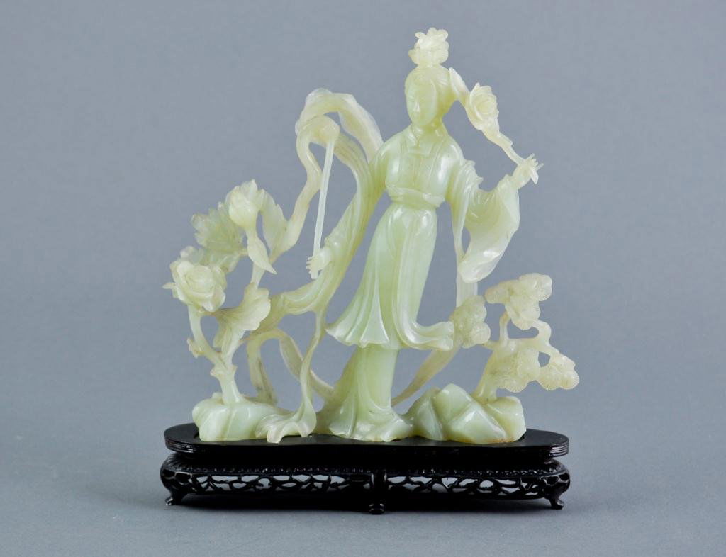 Green hard stone Chinese carving: Depicting a woman in a garden with a wooden stand Condition: some rough edges Size: 10" x 10"some rough edges10" x 10"