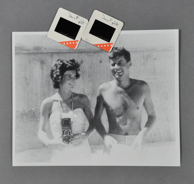 1955-Mar 1, Sen. J.F.K., Palm Beach Photo: (1) Color photograph of J.F.K. with Jackie taken on March 1, 1955, by David Powers. Together with (1) black and white enlargement of the same image, 8" x 10". Mounted, pressure sensitive adhesive labe