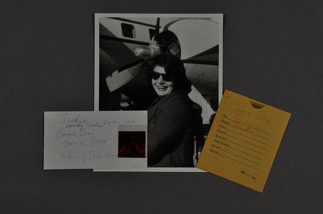 1959-Nov 6, Photo of Jackie Boards "Caroline": (1) Photograph of Jackie as she boards "Caroline" on Nov. 6, 1959, at Coos Bay, Oregon, taken by Dave Powers. Also in a 4" x 5" black and white negative as well as a color negative. Condition: Conditi