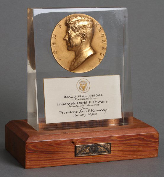 1961-Jan 20, J.F.K. Inauguration Day/ Medal: Bronze Inaugural Medal presented to David Powers from J.F.K. encapsulated in lucite and presented on a wooden base with plaque inscribed made from "Original White House Material Removed in 1950." 8" h