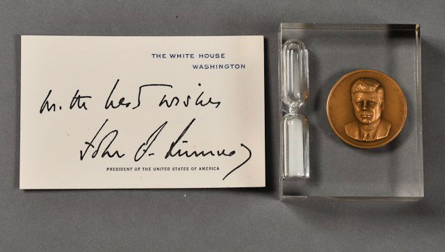 1961-"President Kennedy, Memorabilia": (1) J.F.K. portrait on bronze medallion with the Presidential Seal verso, together with an hour glass encapsulated in lucite, 2 3/4" h. Together with a White House calling card, facsimile signed "All