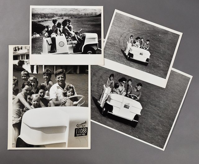 1961-Sept, J.F.K. in Hyannis on Golf Cart: (2) Large format photographs of J.F.K., Jackie and family on golf cart, 11" x 14" each. Together with (2) other examples from the Kennedy Library, 8" x 10" each. Condition: Good