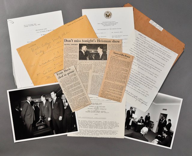 1961-Dec 5, Football Hall of Fame Banquet: A David Powers file including (2) photographs of J.F.K. in office and with recipient of the Heisman Trophy, 8" x 10" each, taken on Dec 5, 1961. (2) Page speech delivered by J.F.K., press releases, (1