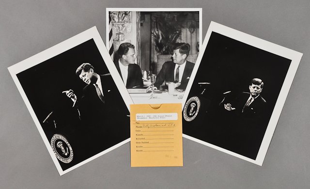 1962-Mar 1, J.F.K., with Billy Graham: (1) Photograph and negative of J.F.K. with Billy Graham on March 1 at the 10th Annual Prayer Breakfast. (2) Photographs of J.F.K. addressing on Feb. 21, 8" x 10" each, from the Kennedy Library. Condit
